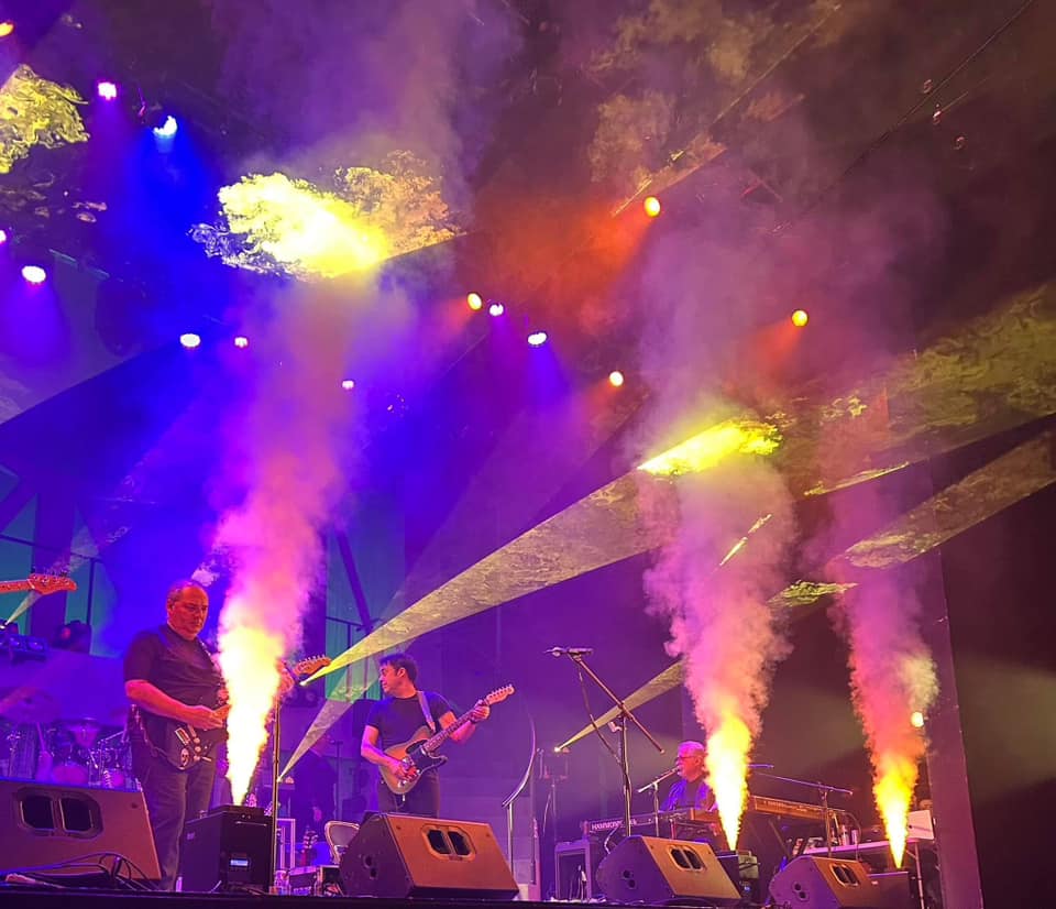 Us And Floyd on a backlit outdoor stage
