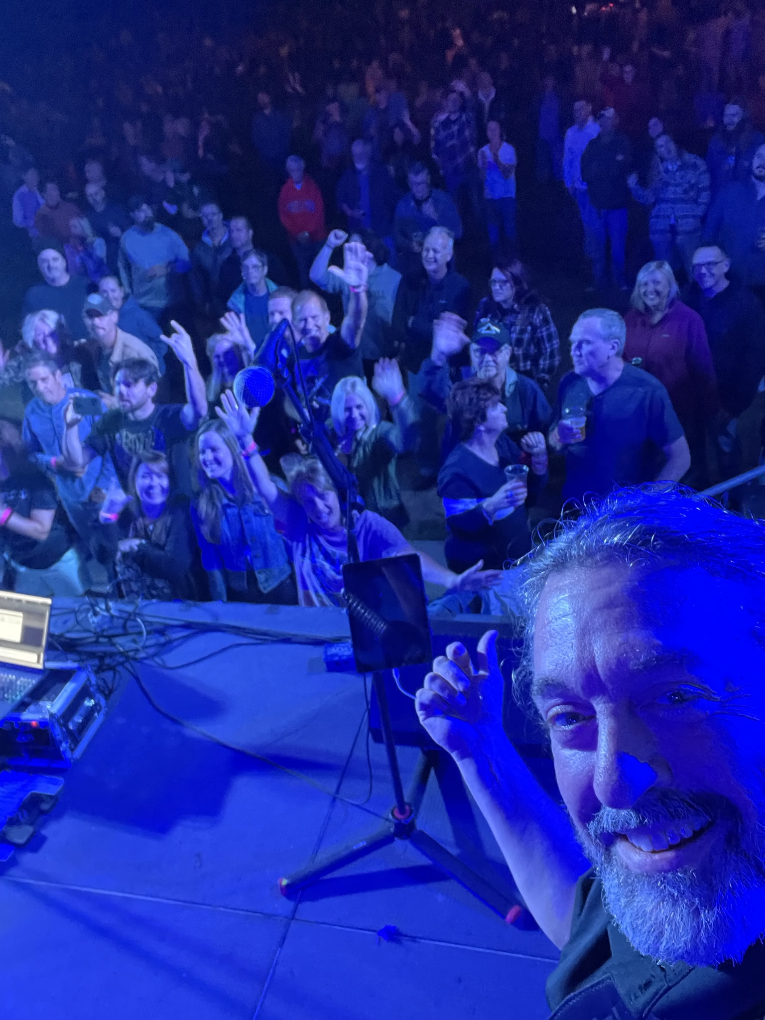 Paul O'Dell at the stage edge after a set, crowd in blue light